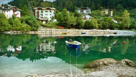 Serene River Reflections of Nature and Homes wallpaper