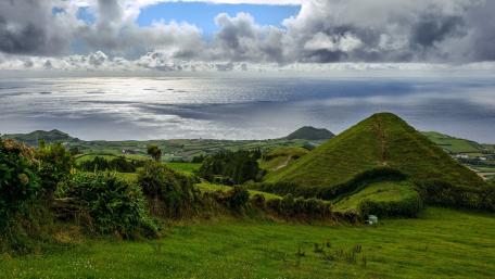 Scenic Green Hill Overlooking the Ocean wallpaper