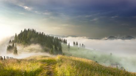 Misty Mountains Under Enveloping Clouds wallpaper
