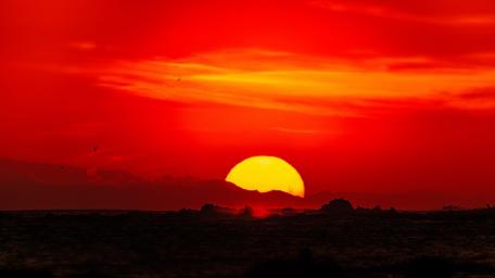 Fiery Sunset Over Calm Waters wallpaper