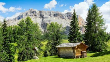 Tranquil Cottage Amidst Majestic Alps Landscape wallpaper