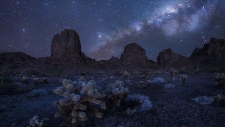 Starlit Magic Over Rugged Terrain wallpaper