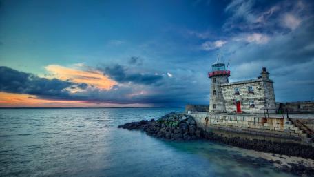 Serene Lighthouse by the Sea at Sunset wallpaper
