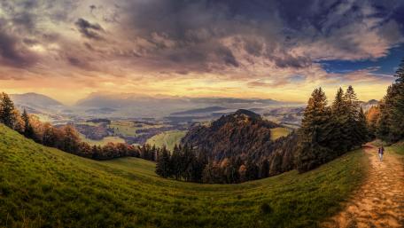 Scenic Mountain Path Under Dramatic Sky wallpaper
