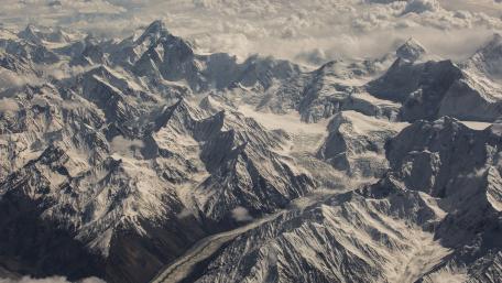 Majestic Mountain Passes Under a Dappled Sky wallpaper