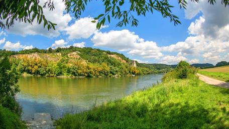 Tranquil River Landscape Under Bright Blue Sky wallpaper
