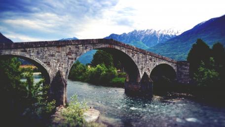 Serene Stone Bridge Over Crystal Clear River wallpaper