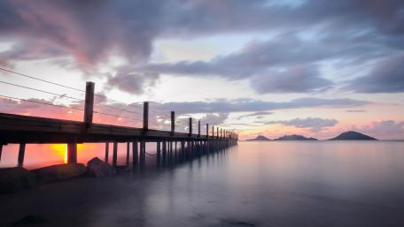 Serene Sunset at the Pier Over the Lake wallpaper