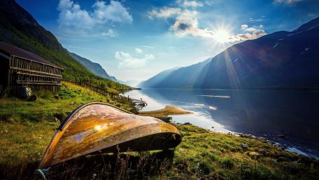 Serene Fjord with a Distant Boat at Sunrise wallpaper