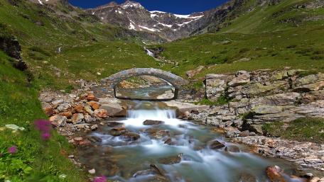Tranquil Stone Bridge Over Mountain River wallpaper