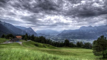 Dramatic Cloudy Landscape Over Majestic Mountains wallpaper