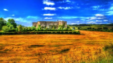 Majestic Castle Surrounded by Golden Fields wallpaper