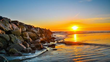 Golden Sunset Over Tranquil Sea Waves wallpaper