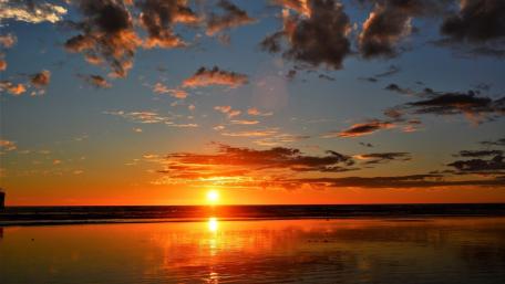 Vibrant Sunset Over the Ocean Shoreline wallpaper