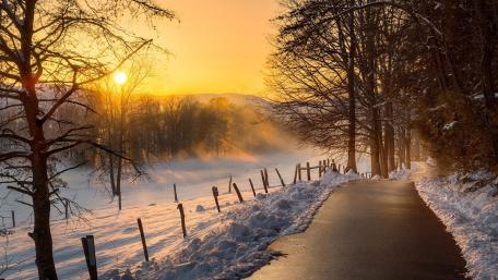 Winter Roadway Beneath a Glowing Sunset wallpaper