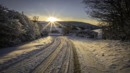 Winter’s Sunrise on a Serene Roadway wallpaper