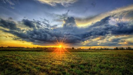Serene Sunset Over A Golden Field wallpaper