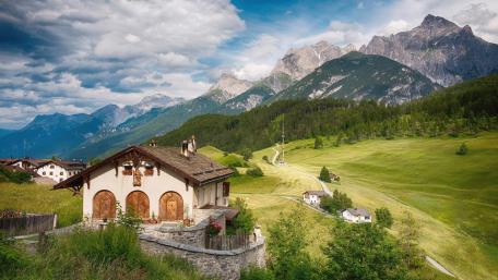 Mountain Cottage Surrounded by Majestic Alps wallpaper