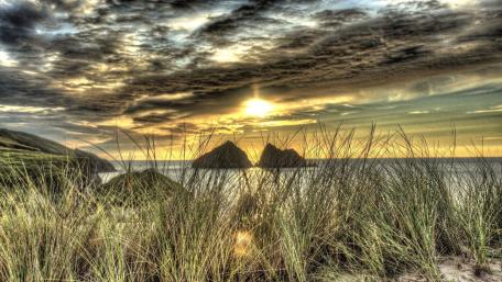 Tranquil Shoreline Under Dramatic Clouds wallpaper