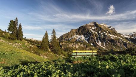 Serene Bench Overlooking Majestic Mountains wallpaper