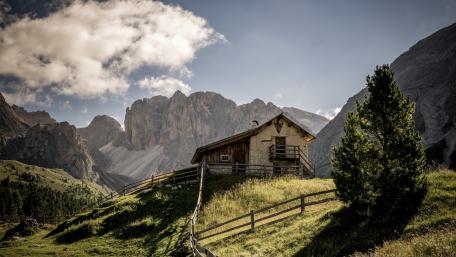 Serene Cottage Nestled in Majestic Mountains wallpaper