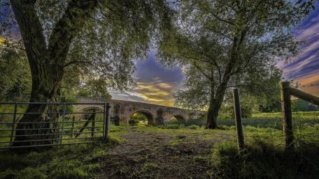 Tranquil Stone Bridge Amidst Nature's Beauty wallpaper