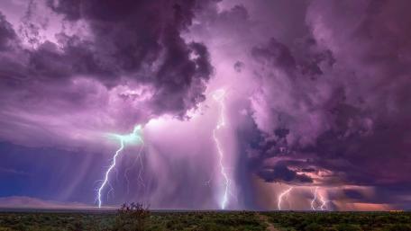 Lighthouse Illuminated by Electrifying Thunderstorm wallpaper