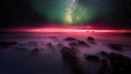 Starry Embrace Over Misty Seas wallpaper