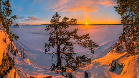 Winter Serenity at Sunset Over the Snowy Landscape wallpaper