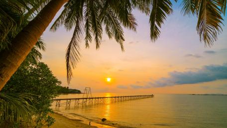 Serene Sunset Over the Pier and Beach View wallpaper
