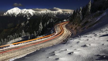 Serene Mountain Pass in Winter Night wallpaper