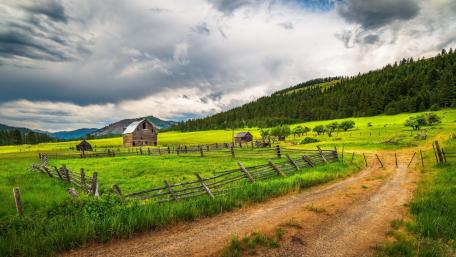 Serene Countryside with Rustic Barns and Rolling Fields wallpaper