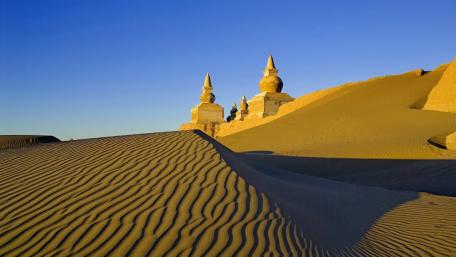 Mystical Desert Castle Under a Blue Sky wallpaper