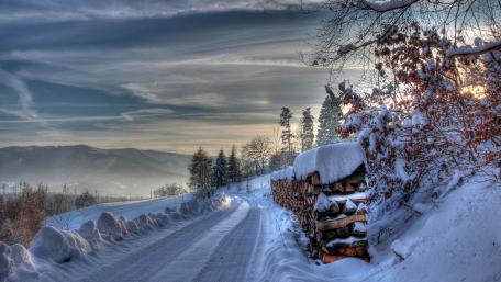 Serene Winter Road Through Snowy Landscape wallpaper