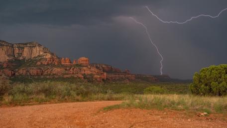 Lightning Illuminates Stormy Mountainscape wallpaper