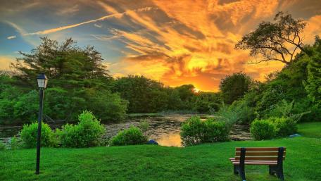 Tranquil Bench by a Fiery Sunset wallpaper