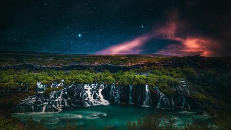 Enchanting Waterfall Under Starry Borealis Sky wallpaper
