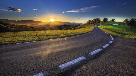Winding Road Under a Golden Sunset wallpaper
