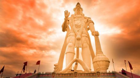 Majestic Statue Against Vibrant Sunset Sky wallpaper