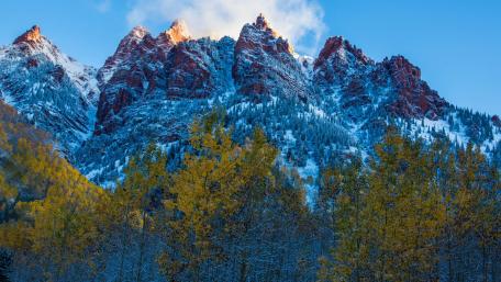 Majestic Mountain Peaks Surrounded by Autumn Colors wallpaper