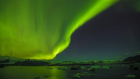 Mesmerizing Aurora Over Icy Landscape wallpaper