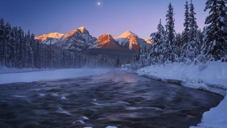 Winter Majesty Over Serene River Scene wallpaper