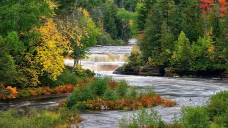 Tranquil Forest River in Autumn Colors wallpaper