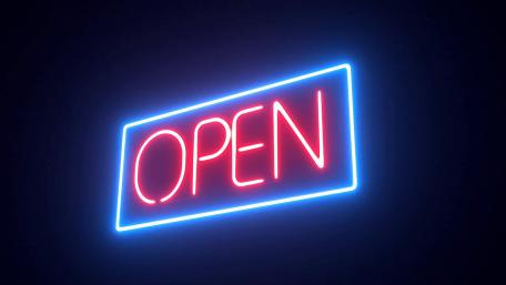 Glowing Neon Open Sign Against Dark Background wallpaper