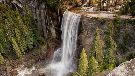 Majestic Waterfall Cascading Down Mountainous Landscape wallpaper