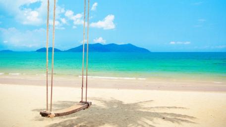 Tranquil Tropical Swing Over Sandy Beach wallpaper