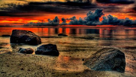 Vivid Sunset Over Rocky Beach Scene wallpaper