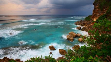 Tranquil Coastal Serenity Amidst Dramatic Skies wallpaper