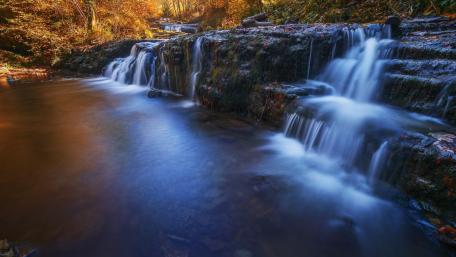 Serene Autumn Waterfall Scene wallpaper