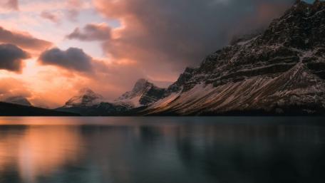 Dusk Falls Over Snow-Capped Peaks and Serene Lake wallpaper